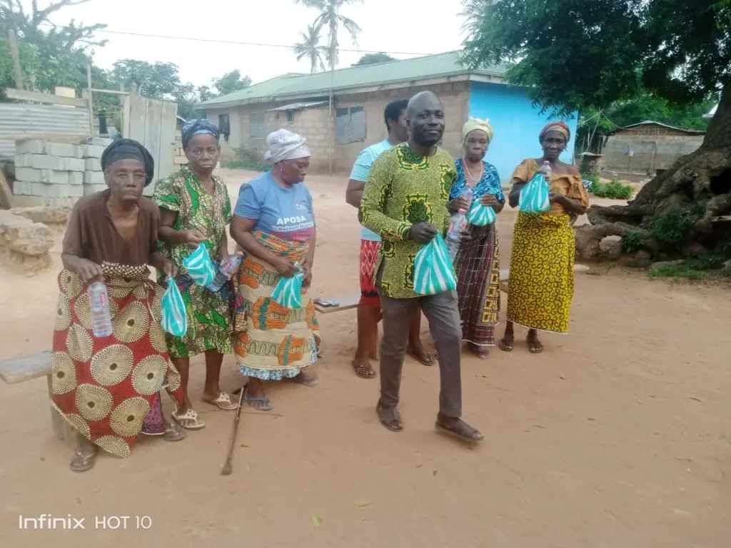 Widows in Ayenya supported by Living the Dream Foundation smiling at a community meeting.